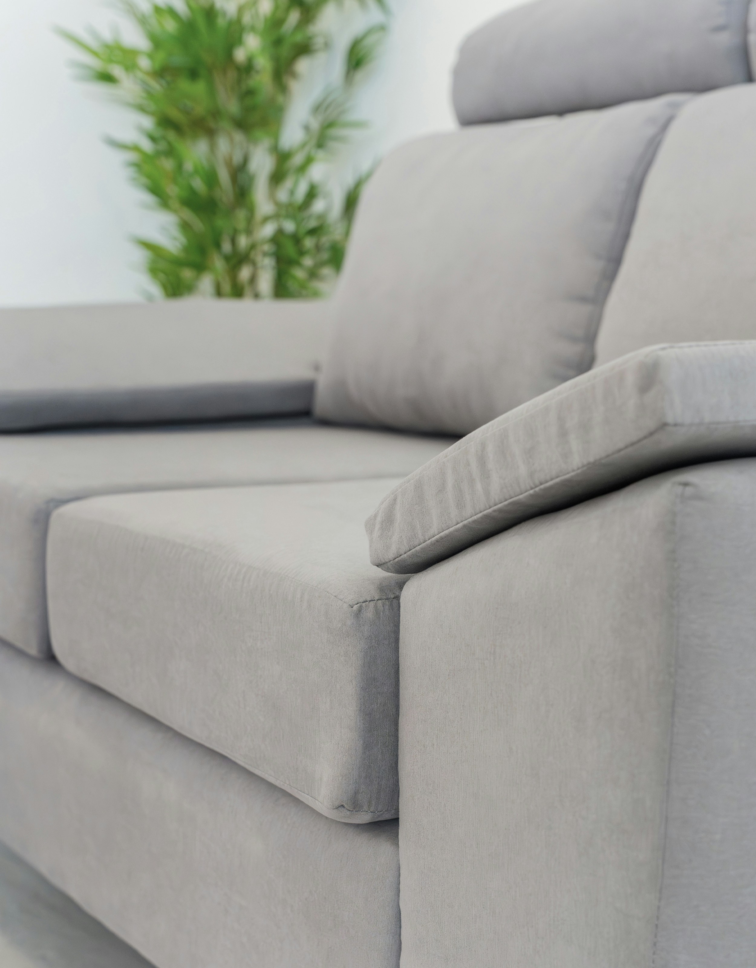 A modern grey sofa with plush cushions.
